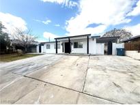 Charming home with a black and white exterior and a spacious driveway at 619 Brush St, Las Vegas, NV 89107