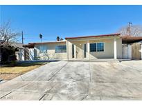 Charming single story home with large front windows and covered entry way at 619 Brush St, Las Vegas, NV 89107