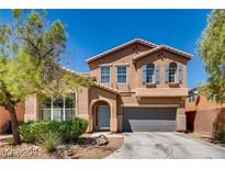 Two-story house with gray doors and blue shutters at 10161 Kermode Ct, Las Vegas, NV 89178