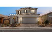 Two-story house with a beige facade and a two-car garage at 2124 Danzinger Pl, Henderson, NV 89044