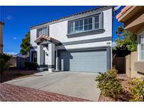 Two-story home showcasing desert landscaping, a gray color scheme, and a two-car garage at 3335 Cheltenham St, Las Vegas, NV 89129