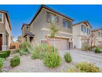 Two-story house with gray exterior, landscaped yard, and two-car garage at 6201 Ashley Hills Ave, Las Vegas, NV 89141