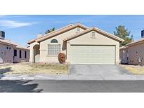 Single-story house with attached garage and well-maintained lawn at 7132 Junction Village Ave, Las Vegas, NV 89129