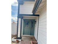 Inviting front entrance with a teal door and brick walkway at 8101 Spur Ct, Las Vegas, NV 89145