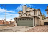 Two-story house with a gray garage door and a spacious driveway at 8101 Spur Ct, Las Vegas, NV 89145