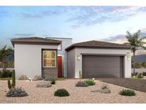 One-story home with desert landscaping, two-car garage, and red front door at 869 Bittern Lake St, Henderson, NV 89011