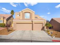 Two-story house with two-car garage and desert landscaping at 9700 Port Orange Ln, Las Vegas, NV 89134