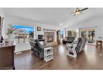 Bright living room with fireplace, hardwood floors, and comfy seating at 1021 Bourbon St, Pahrump, NV 89048