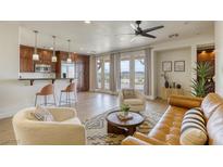 Spacious living room with leather sofa and access to a patio at 1234 Calcione Dr, Henderson, NV 89011