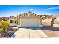 Tan one-story house with a two-car garage and desert landscaping at 2755 Sunken Ship St, Laughlin, NV 89029