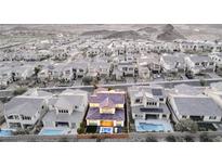 Expansive aerial view of a home with a private pool in a well-planned community with mountain views at 30 Hilltop Crest St, Henderson, NV 89011
