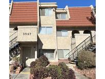 Two-story condo building with Spanish tile roofing and landscaping at 3597 Arville St # 203B, Las Vegas, NV 89103