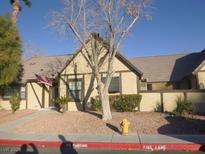 Cute stucco home with dark brown trim, American flag, and fire hydrant at 3940 Edgemoor Way, Las Vegas, NV 89121