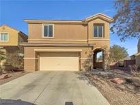 Two-story house with attached garage and desert landscaping at 7100 Estrella De Mar Ave, Las Vegas, NV 89131