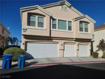 Tan two-story house with two-car garage and landscaping at 8834 Duncan Barrel Ave # 103, Las Vegas, NV 89178