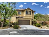 Two-story house with brown garage door and landscaping at 10489 Bolting Cloud Dr, Las Vegas, NV 89178