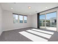 Spacious bedroom with large windows and private balcony access at 11327 Gravitation Dr, Las Vegas, NV 89135