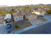 Aerial view of a house with a landscaped yard and two-car garage at 1426 Radig Ct, Boulder City, NV 89005