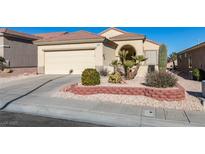 Single-story house with attached garage, landscaping, and desert plants at 1848 Mountain Ranch Ave, Henderson, NV 89012