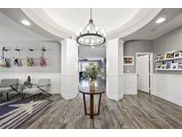 Bright and spacious entry with hardwood floors and elegant light fixture at 2365 Boretto St, Henderson, NV 89044