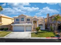 Two-story house with a three-car garage and manicured lawn at 4654 Stuttgart St, Las Vegas, NV 89147