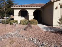 Landscaped front yard with rock garden and mature shrubs at 4694 E Lucera Ct, Pahrump, NV 89061