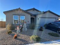 One-story home with landscaped front yard, two-car garage, and decorative snowmen at 471 Desoto Falls St, Indian Springs, NV 89018