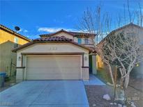 Two-story house with beige exterior, attached garage, and landscaping at 4823 Jubilee Diamond Ct, Las Vegas, NV 89139