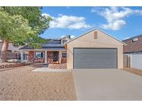 Single-story home with grey garage door and landscaped yard at 5420 Doe Ave, Las Vegas, NV 89146