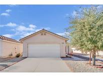 Single-story house with a white garage door and landscaped yard at 5533 Ramirez St, North Las Vegas, NV 89031