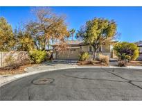 Tan house with a two-car garage and mature landscaping at 5744 Serenity Haven St, North Las Vegas, NV 89081