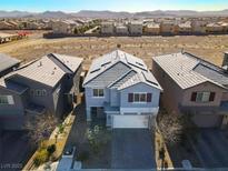 Aerial view of two-story house with solar panels and neighborhood in background at 5921 Roaring Canyon Ct, Las Vegas, NV 89139