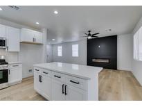 Modern kitchen with white cabinets, quartz countertops, and stainless steel appliances at 5934 Clear Valley Ave, Las Vegas, NV 89142