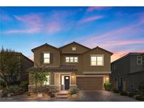 Two-story house with tan exterior, dark gray door, and attached garage at 6332 Ava Ridge Ave, Las Vegas, NV 89141