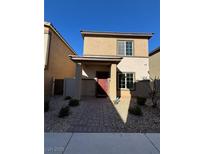 Two-story house with red door and landscaped yard at 7355 Sunray Point St, North Las Vegas, NV 89084