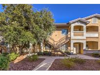 Two-story condo building with landscaped grounds and stairs at 8805 Jeffreys St # 2019, Las Vegas, NV 89123