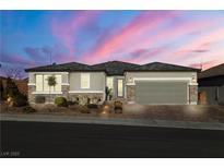 One-story home with gray siding, stone accents, and a landscaped front yard at 9820 Maiden Pink Ave, Las Vegas, NV 89149