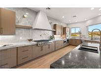 Gourmet kitchen featuring modern cabinetry, high-end appliances, and expansive island at 22 Anthem Pointe Ct, Henderson, NV 89052