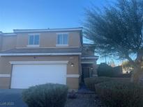 Two-story home with a two-car garage and well-maintained landscaping offering charming curb appeal at 3349 Morning Amber St, North Las Vegas, NV 89032
