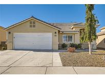 Single-story house with a two-car garage and landscaped front yard at 3709 Ferrell St, North Las Vegas, NV 89032