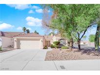 Single-story home with a two-car garage and landscaped front yard at 4509 Crimson Leaf Dr, Las Vegas, NV 89130