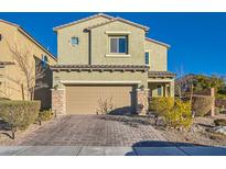 Two-story house with light beige siding, brown garage door, and landscaped front yard at 6310 Echo Mountain St, Las Vegas, NV 89115