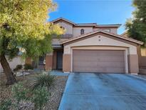 Two-story house with attached garage and landscaping at 11193 Falesco Ave, Las Vegas, NV 89138