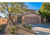 Two-story house with attached garage and landscaping at 11193 Falesco Ave, Las Vegas, NV 89138