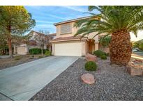 Two-story house with attached garage and landscaped yard at 179 Andada Dr, Henderson, NV 89012