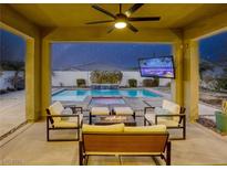 Relaxing backyard with a sparkling pool, patio furniture, and fire pit at 2576 Desante Dr, Henderson, NV 89044