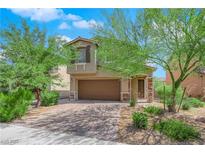 Two-story house with brown garage door and landscaped front yard at 3792 Nerine Pass Way Ave, North Las Vegas, NV 89031