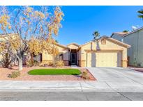 Single-story house with a landscaped front yard and two-car garage at 3918 Champagne Wood Dr, North Las Vegas, NV 89031