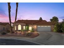 Single-story house with tan walls, tile roof, and a two-car garage at 4609 Snowpoint Ct, Las Vegas, NV 89130