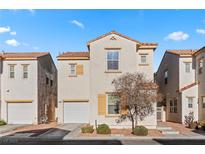 Two story house with tan exterior, white garage door, and landscaping at 5400 Flowing Spring St, Las Vegas, NV 89122